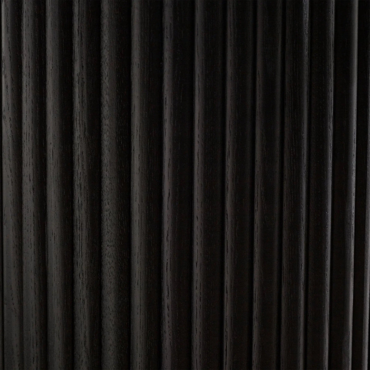 Black fluted wood detail on side table door, closeup showing vertical grooves