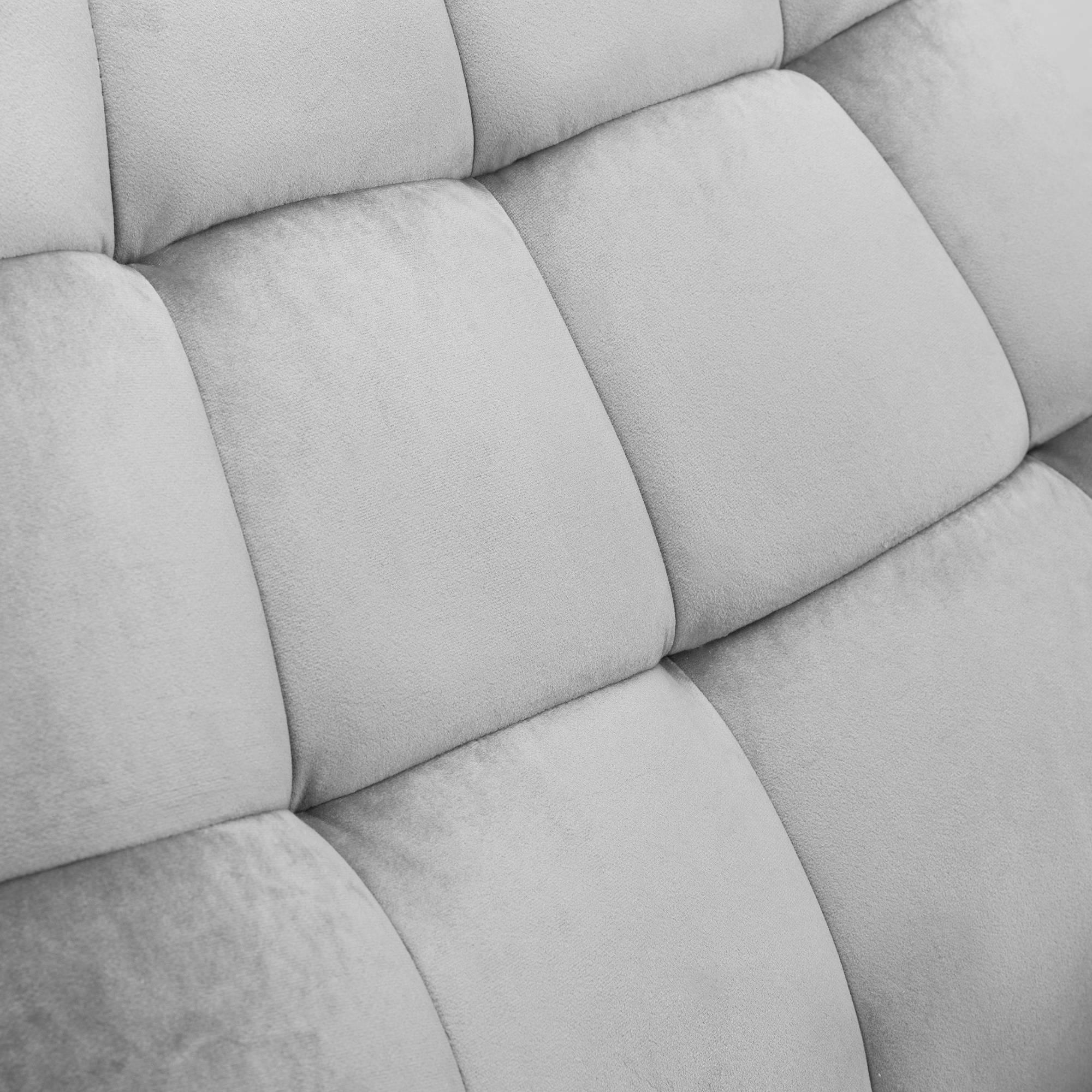 Close-up of velvet chair upholstery showing soft grey padded detail