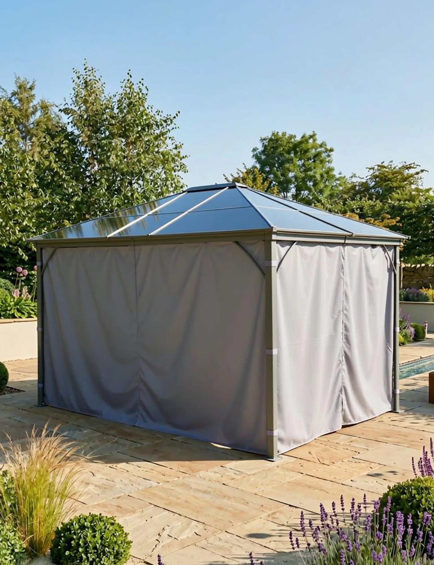 Garden gazebo with metal frame and closed grey curtains on stone patio