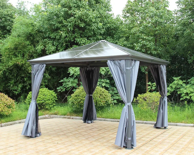 Grey metal garden gazebo with curtains on patio, surrounded by greenery