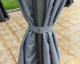 Grey outdoor gazebo curtain tied to metal frame on tiled patio