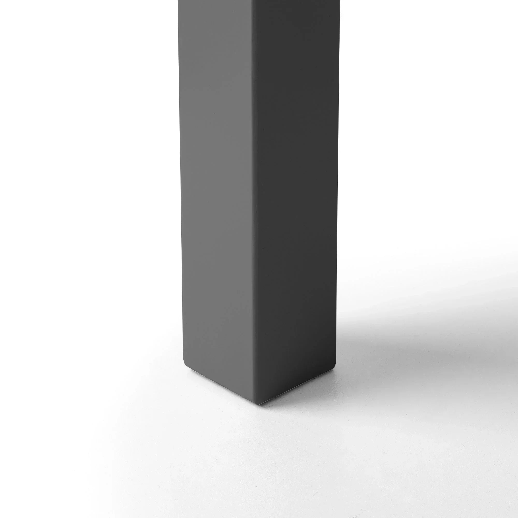 Anthracite metal single bed leg with matte finish, close-up detail on white floor