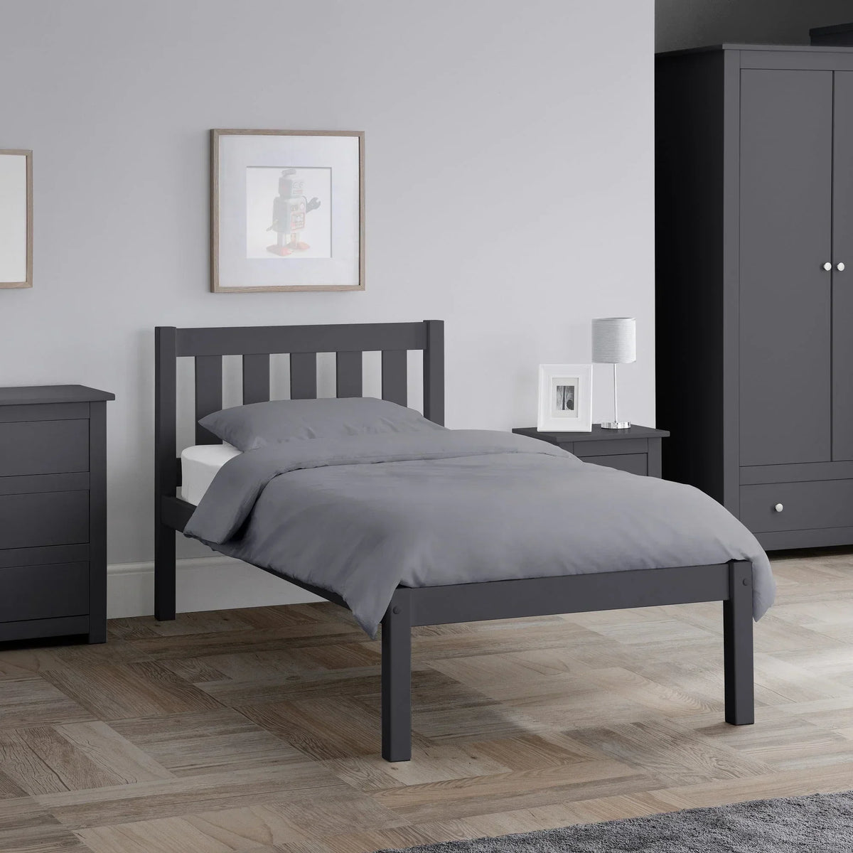 Anthracite single bed with slatted headboard in modern bedroom, grey bedding, wood floor