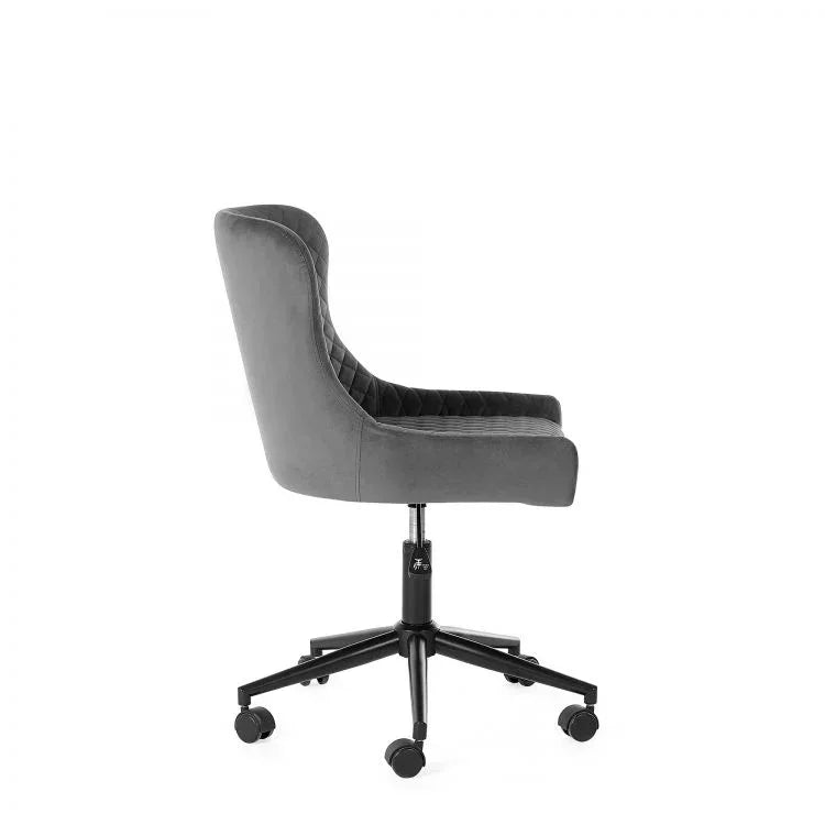 Grey velvet office chair with quilted seat, side view on black metal caster base