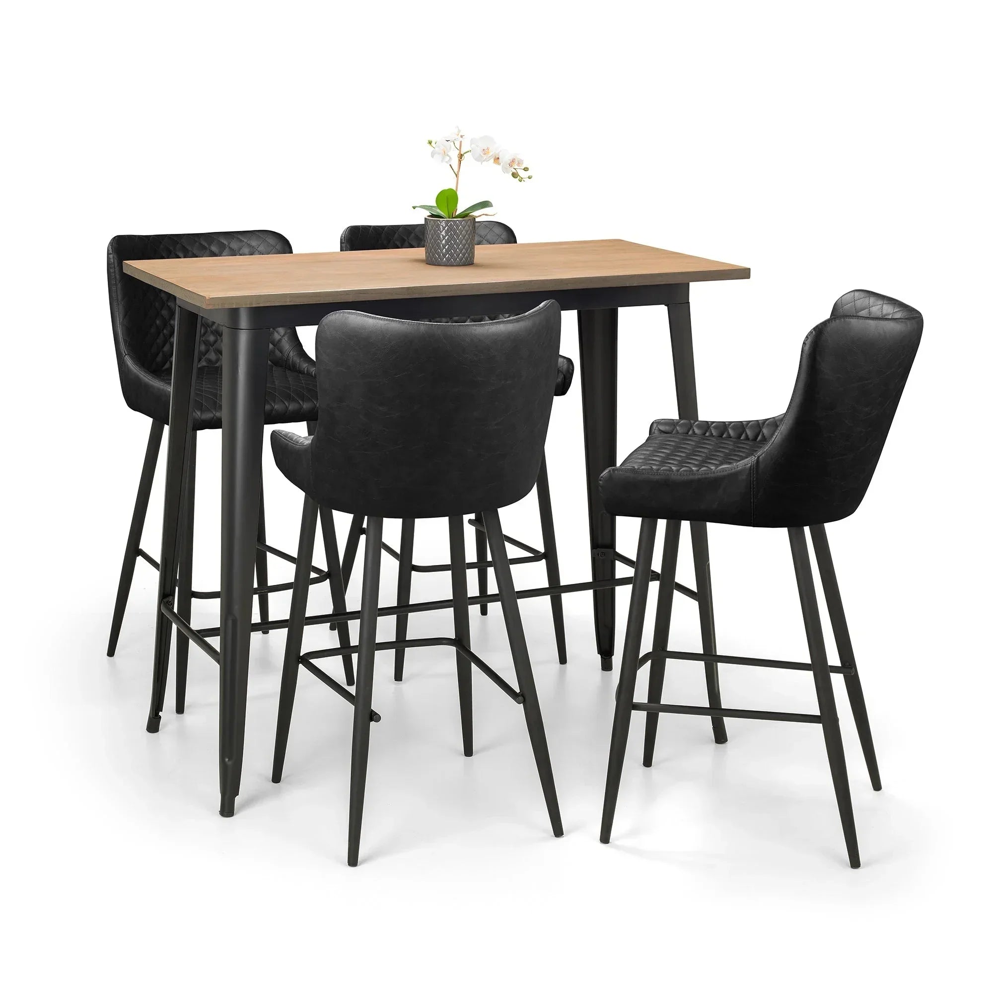 Black faux leather bar stools with quilted seats around a tall wood dining table