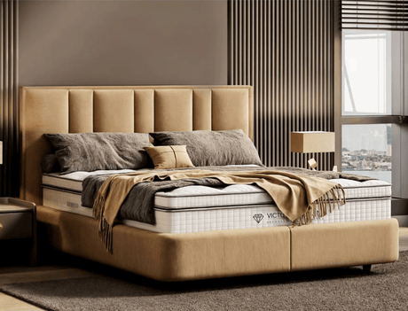 Deep quilted mattress styled with cushions and throws in contemporary bedroom