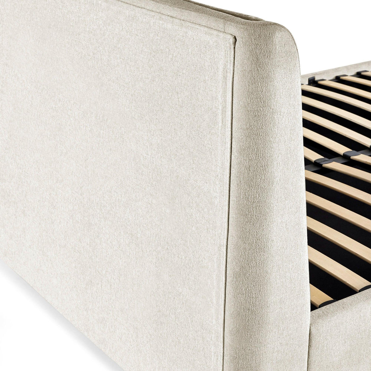 Beige upholstered bed frame with wooden slats, closeup of headboard and side panel