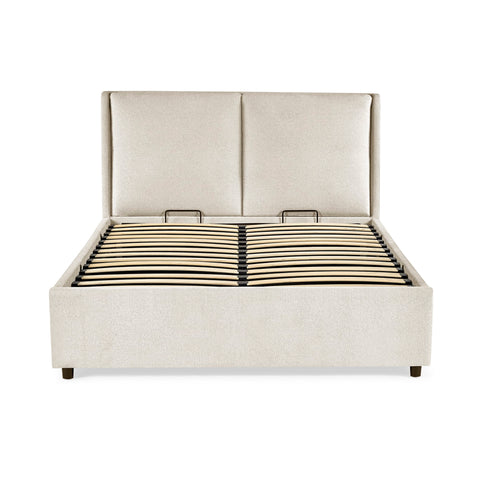Beige upholstered bed frame front view without mattress showing wooden slatted base on black frame