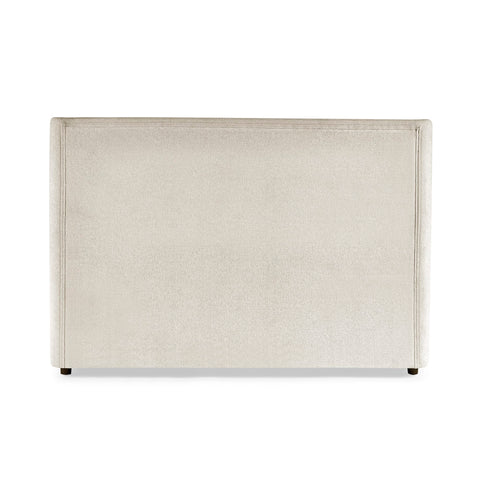 Beige upholstered headboard with simple stitched border and dark wooden feet on white background