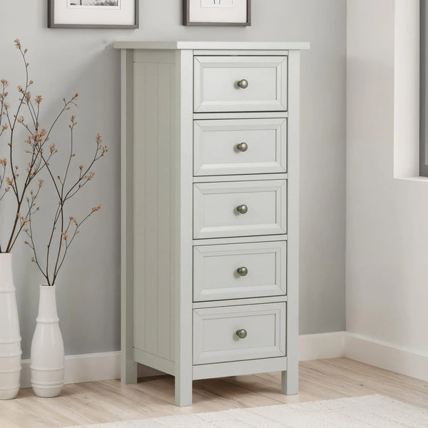 White tallboy chest of drawers with five drawers in modern bedroom corner