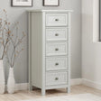 White tallboy chest of drawers with five drawers in modern bedroom corner