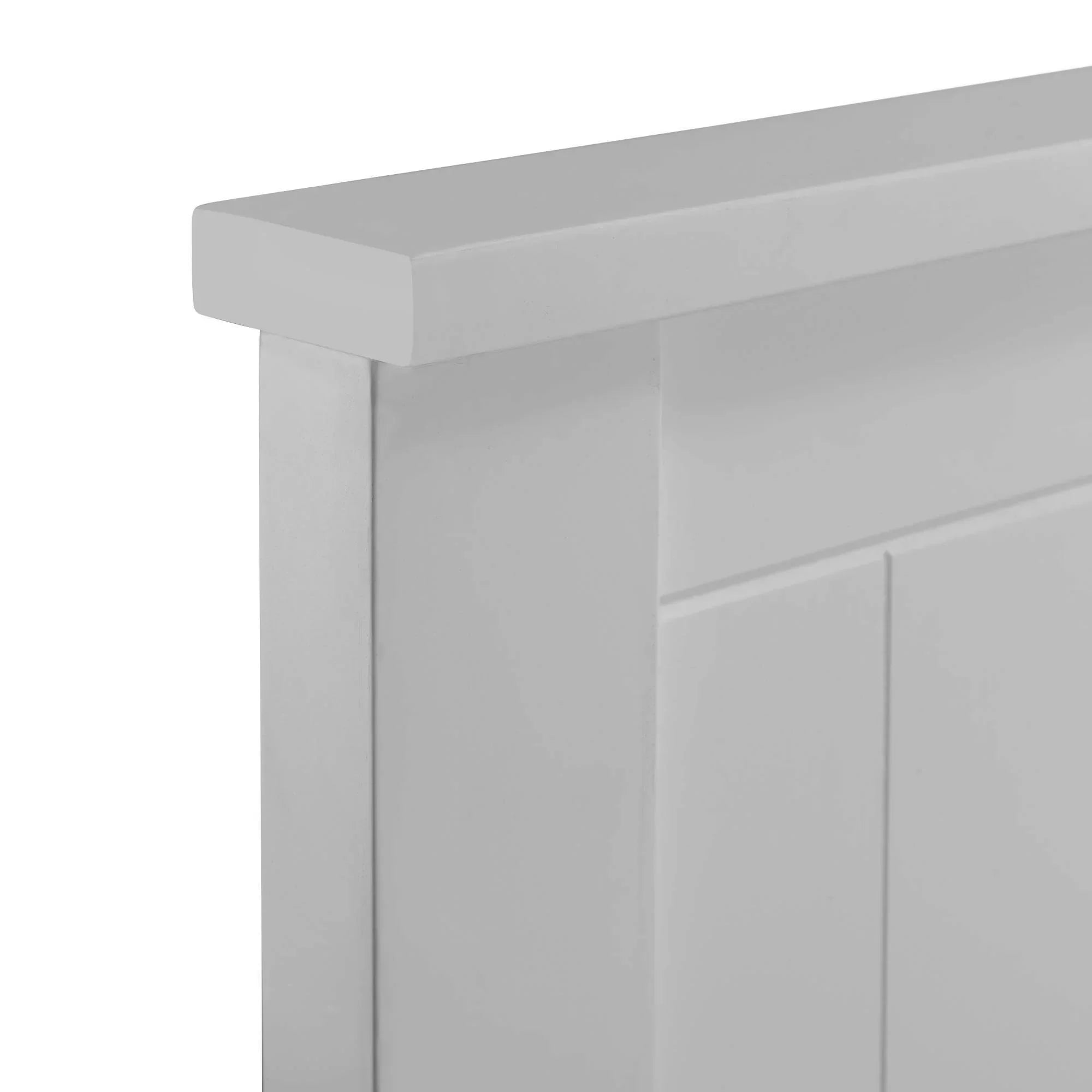 Closeup of white wooden headboard with panel detail and smooth finish