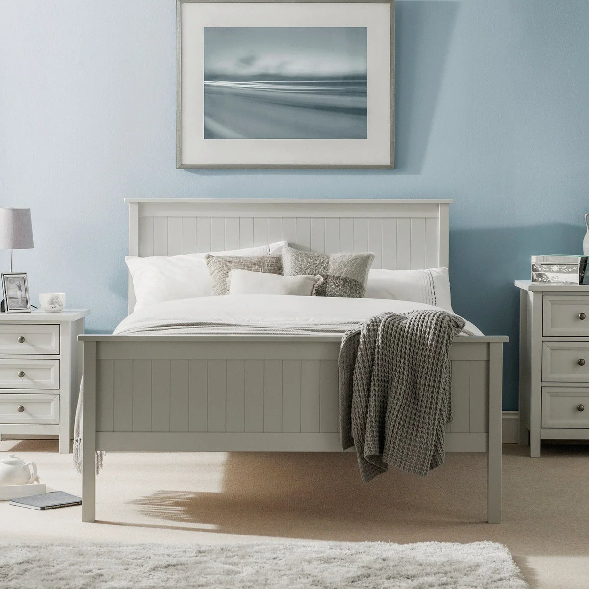 Maine grey bed with panel detailing, white bedding and throw, between two bedside tables