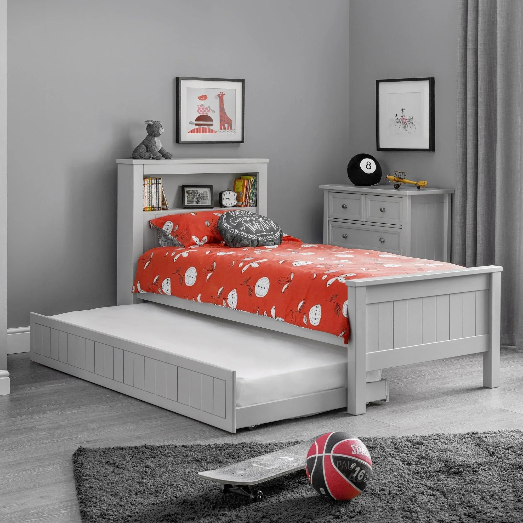 Grey bookcase bed with pull-out trundle in modern kids room, red bedding, wooden floor