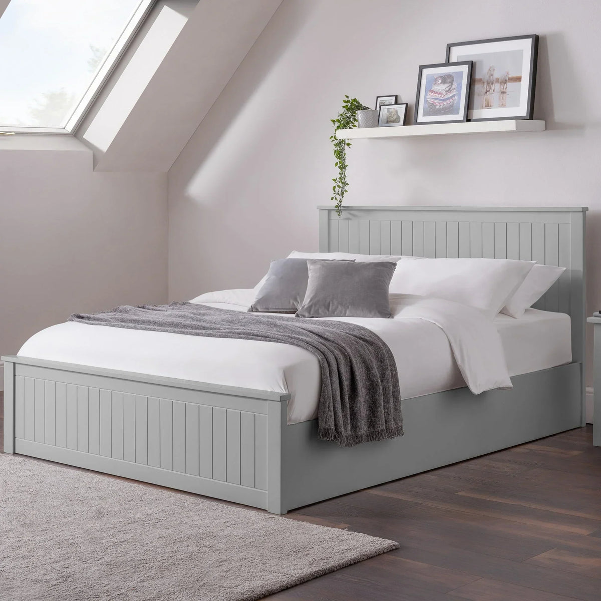 Dove grey ottoman storage double bed with paneled headboard in modern bedroom