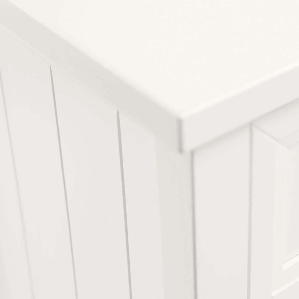 Corner detail of Maine white chest with paneled finish and smooth surface