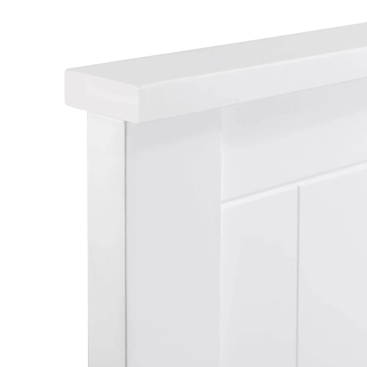 White wood panel bed headboard with grooved detail, close corner view
