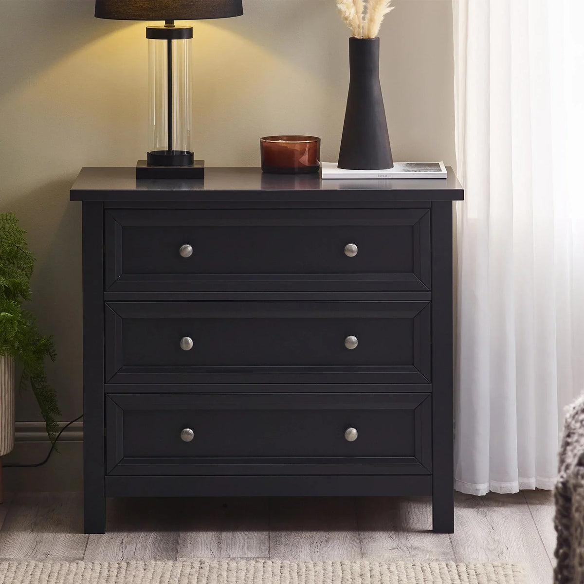 Anthracite three drawer wide chest with metal knobs in bedroom setting