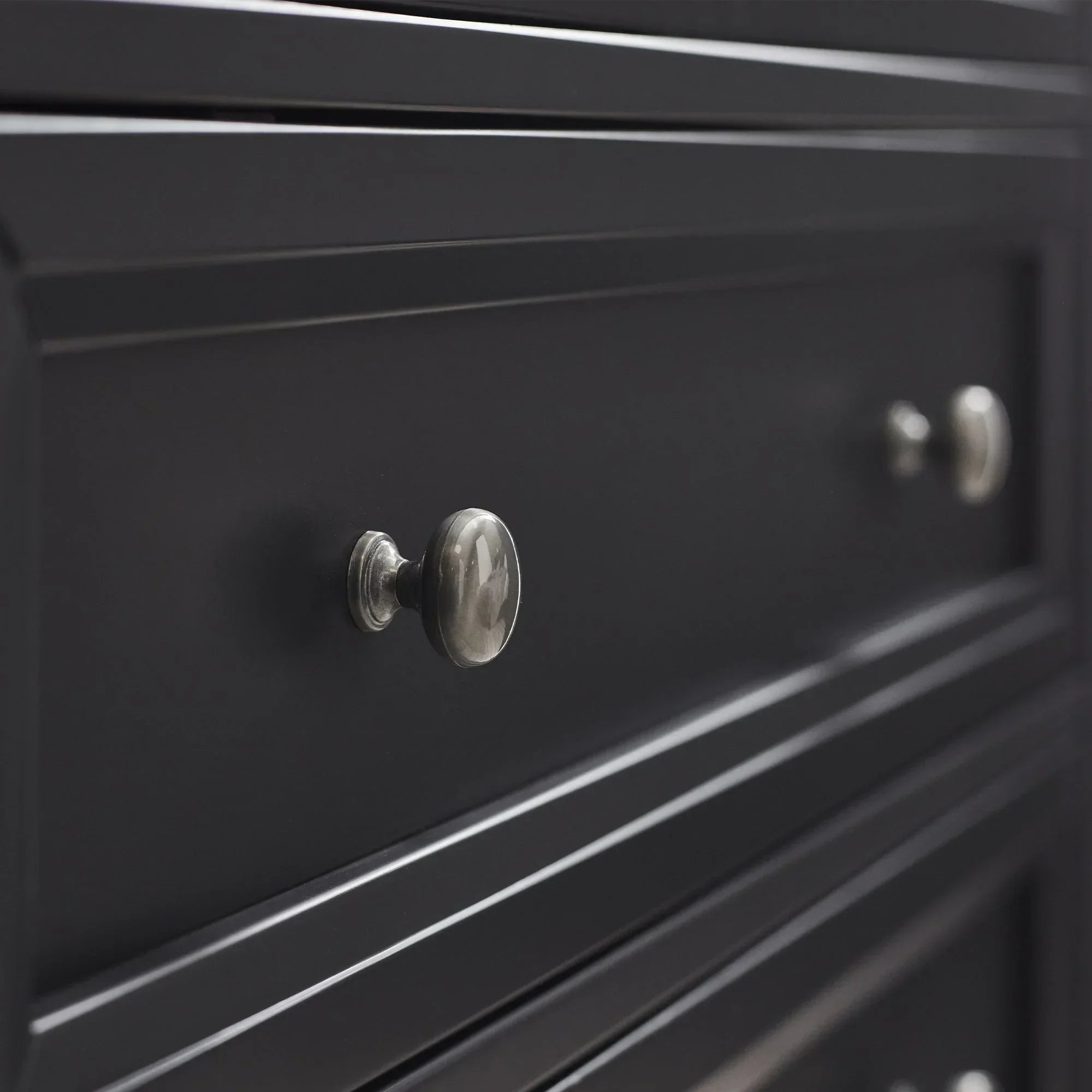 Anthracite two drawer chest close-up with metal knobs and wood panel detailing