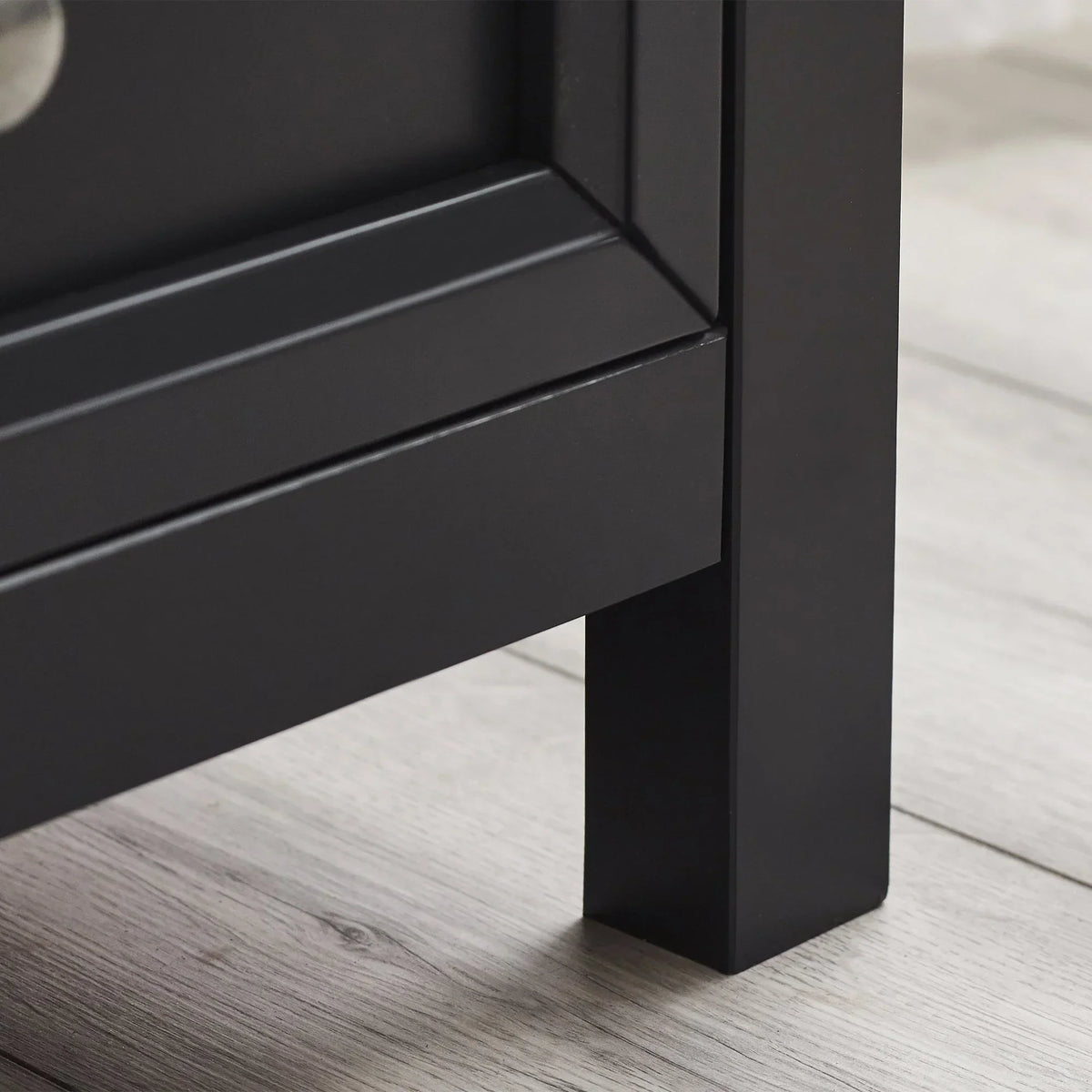 Anthracite 2 drawer chest matte finish corner and leg detail on light wood floor