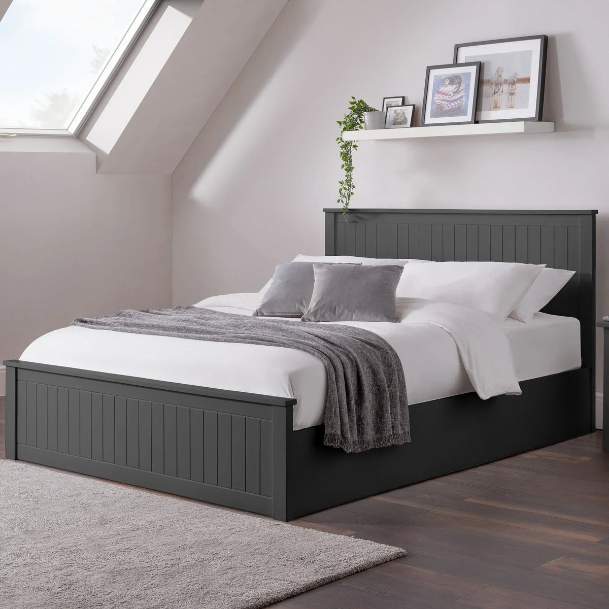 Anthracite ottoman storage double bed with panelled headboard in modern bedroom