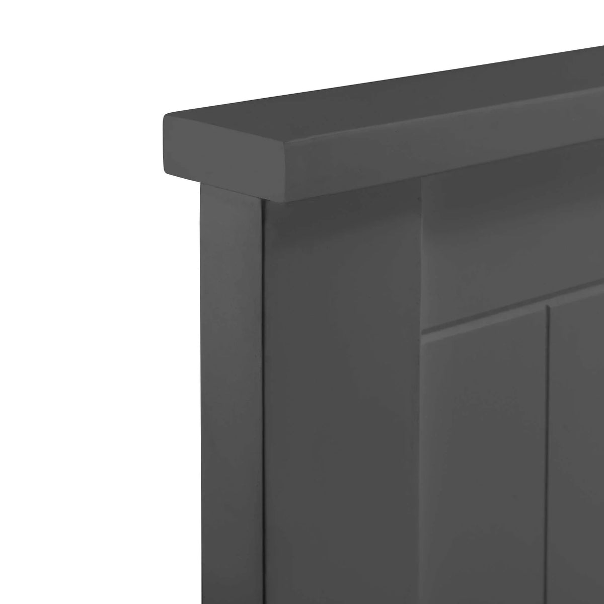 Closeup of dark grey wooden bed frame headboard corner detail