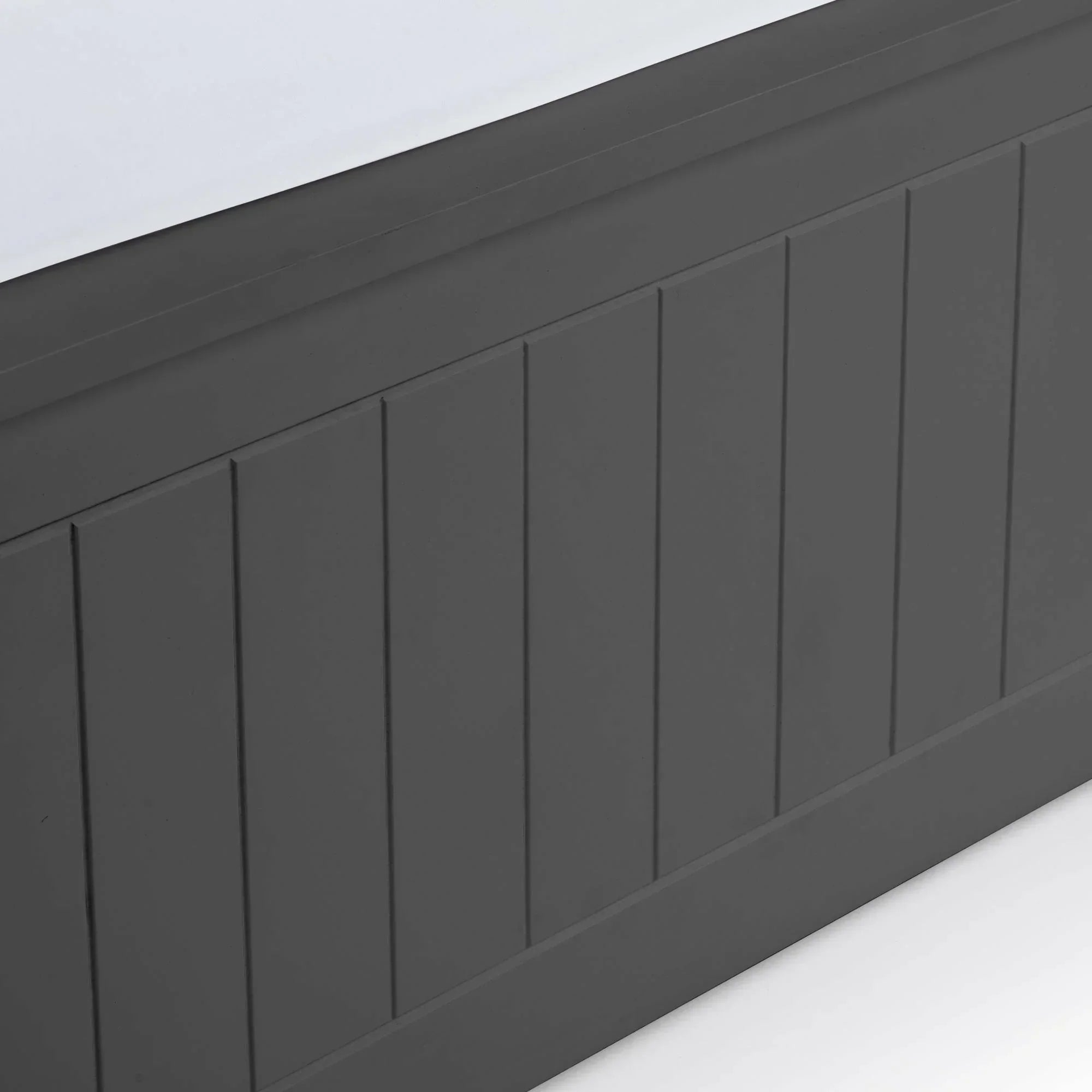 Close-up of dark grey wooden bed frame footboard with vertical panel detail