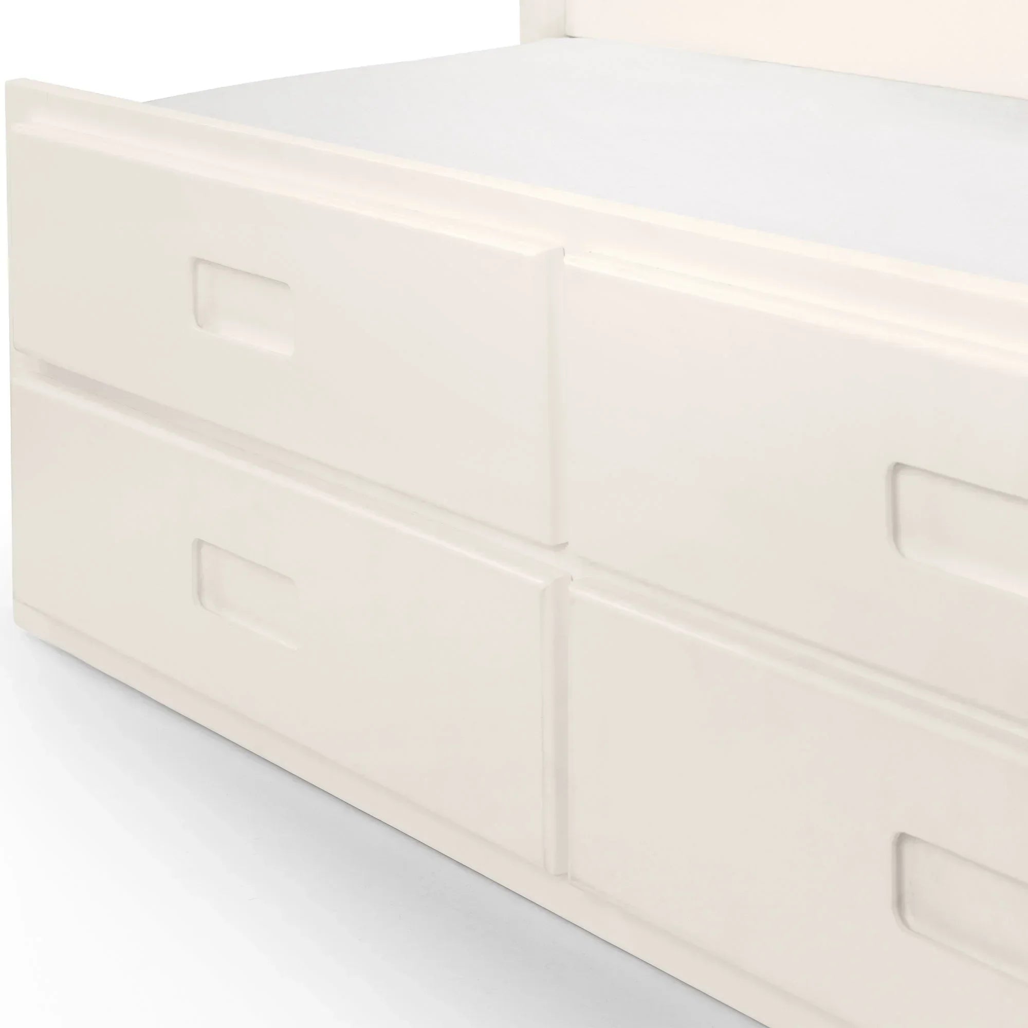 White single daybed with built-in storage drawers, close-up of drawer handles and base