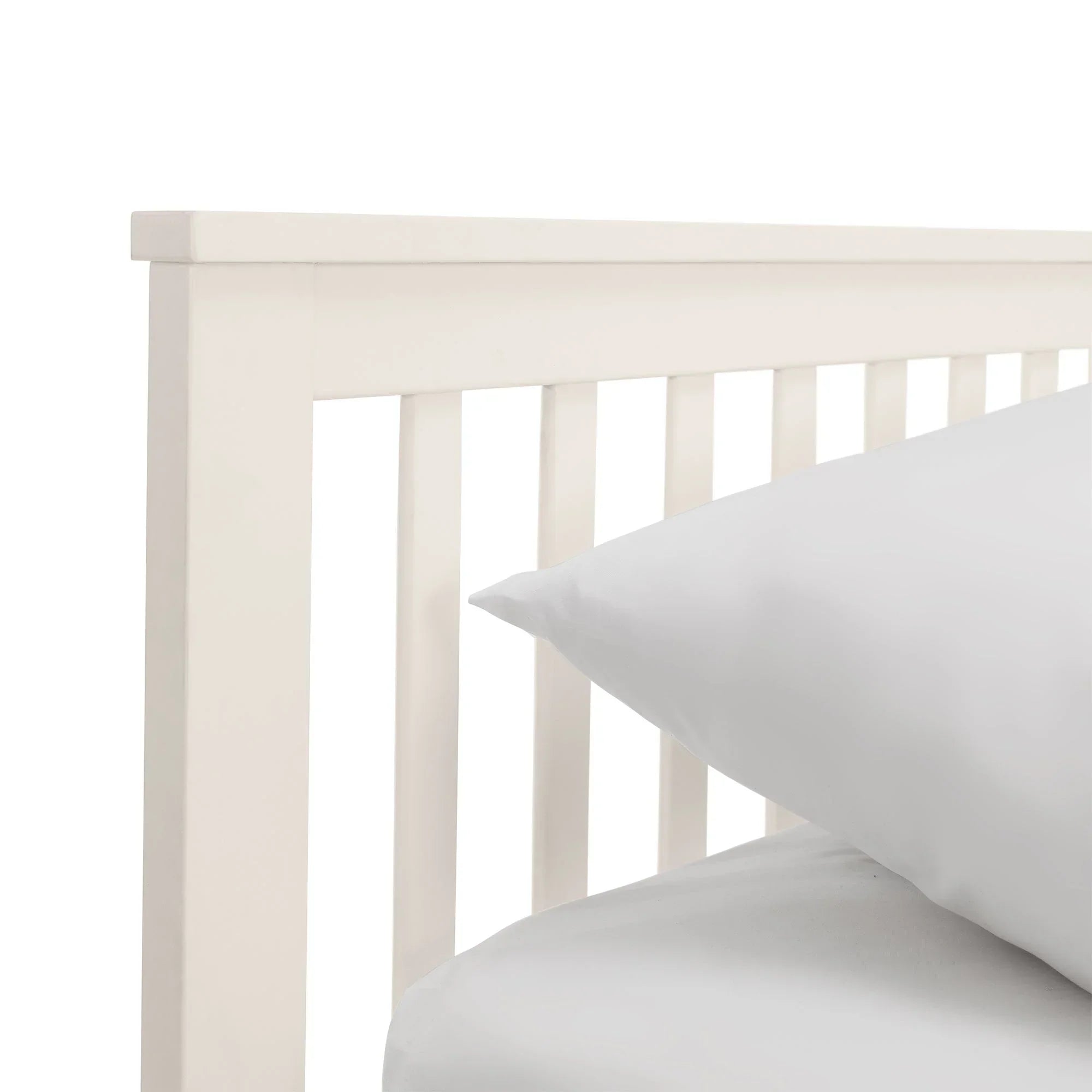 White single daybed frame with vertical slats and white bedding detail view
