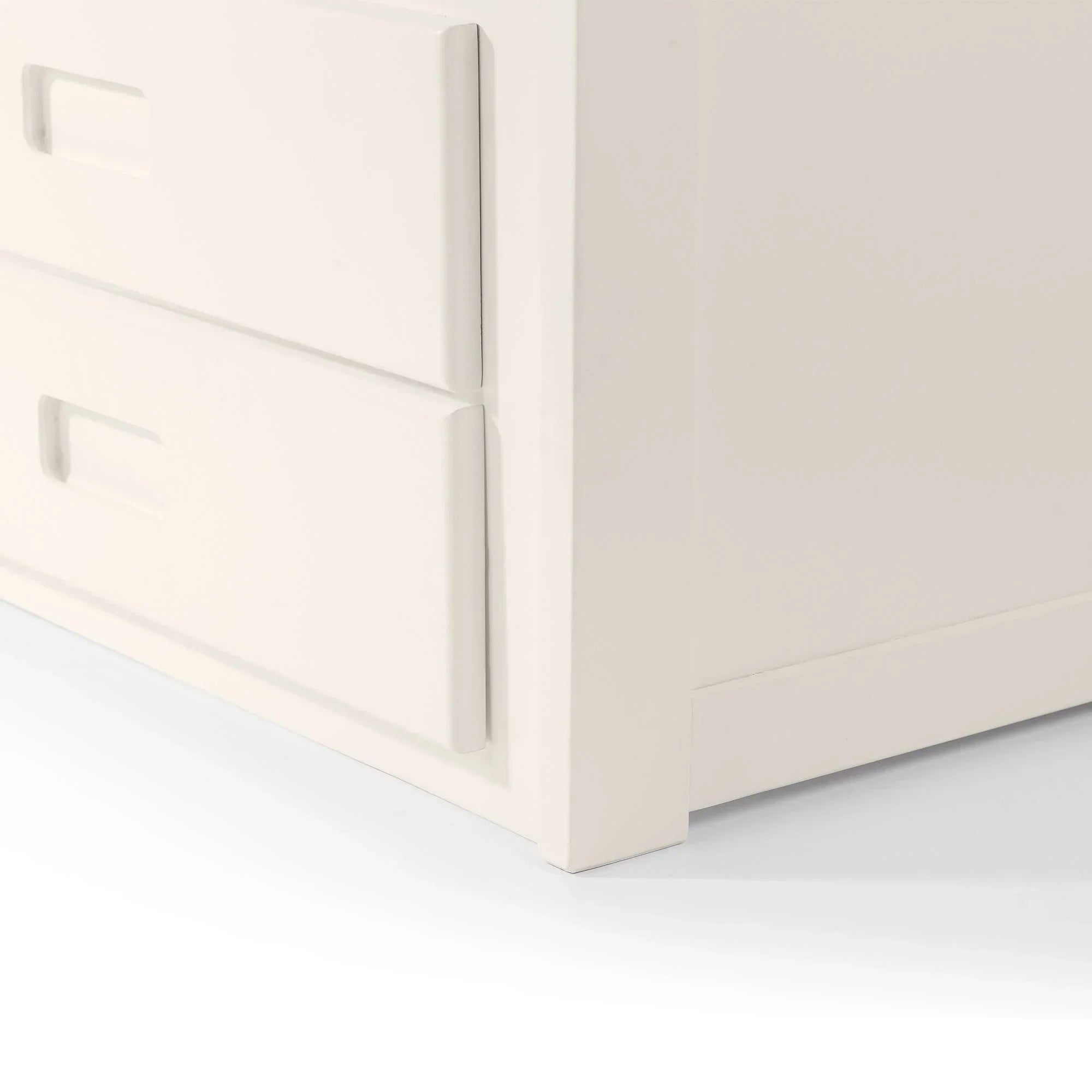 White daybed storage drawers with inset handles, close-up of corner and drawer detail