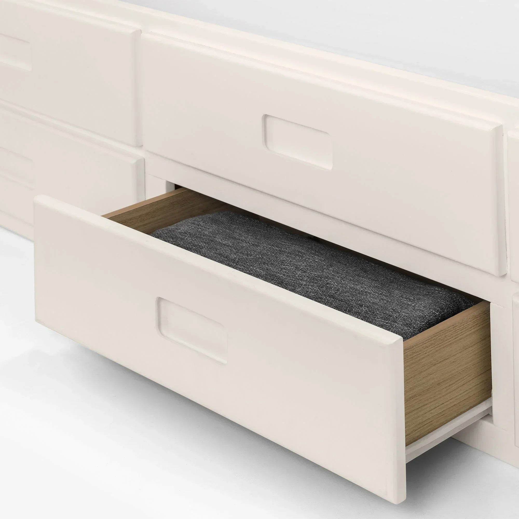 Maisie single daybed with open underbed storage drawer holding folded blanket