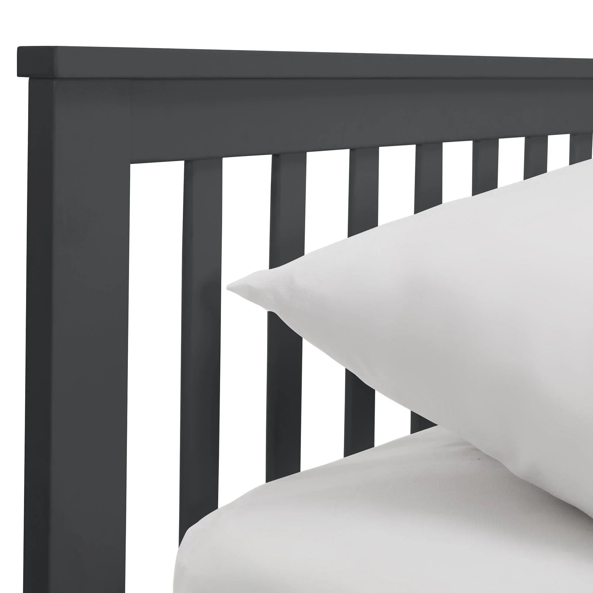 Anthracite single daybed headboard with vertical slats and white bedding corner detail