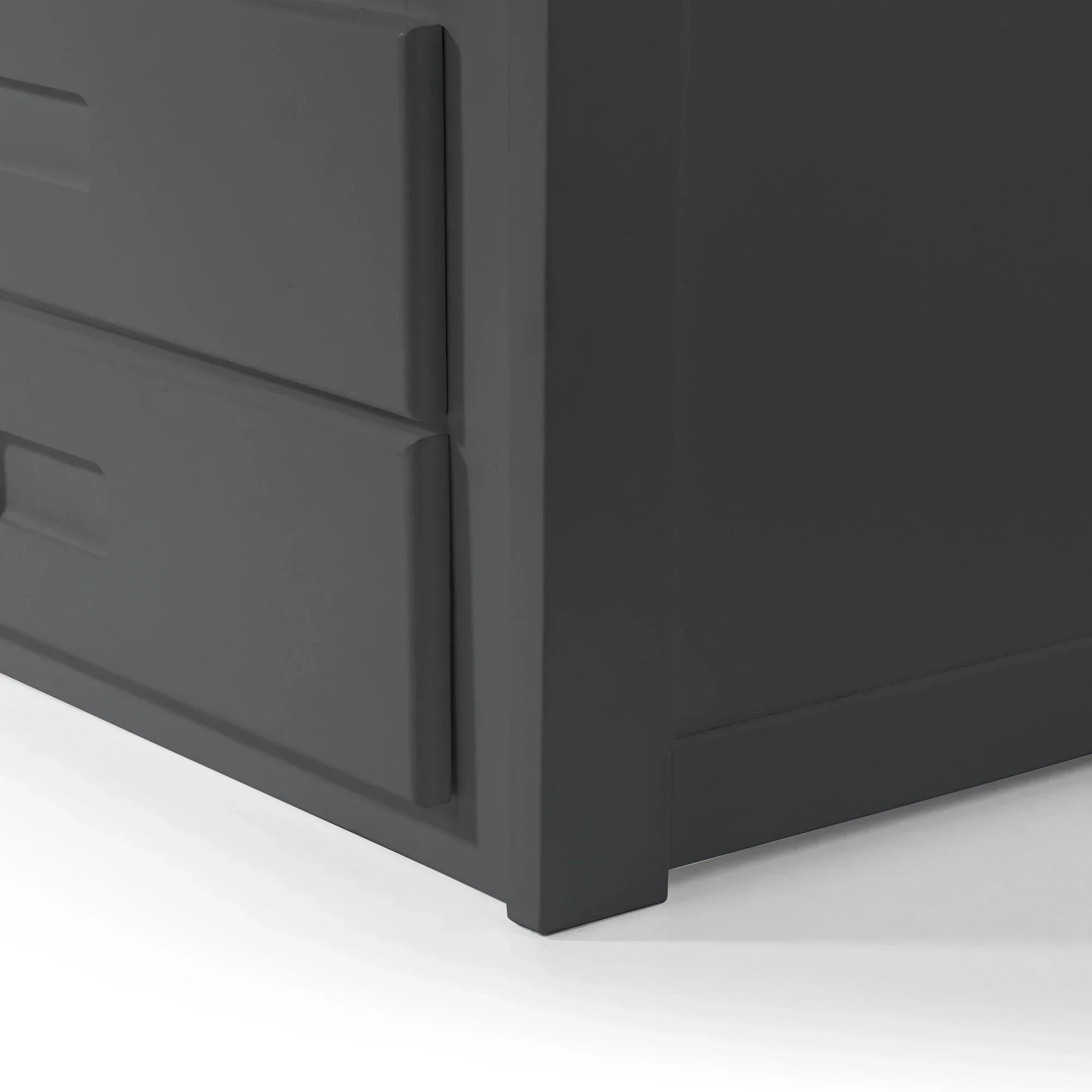 Closeup of charcoal grey chest of drawers corner showing modern handle detail
