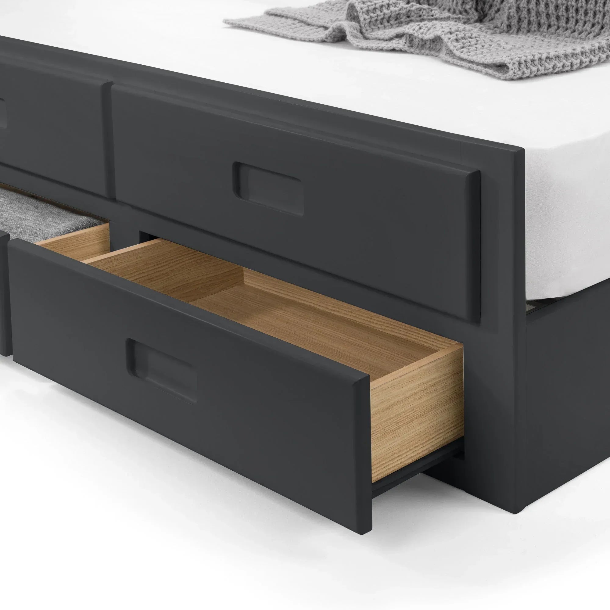 Black storage bed with open lower drawer showing wood interior