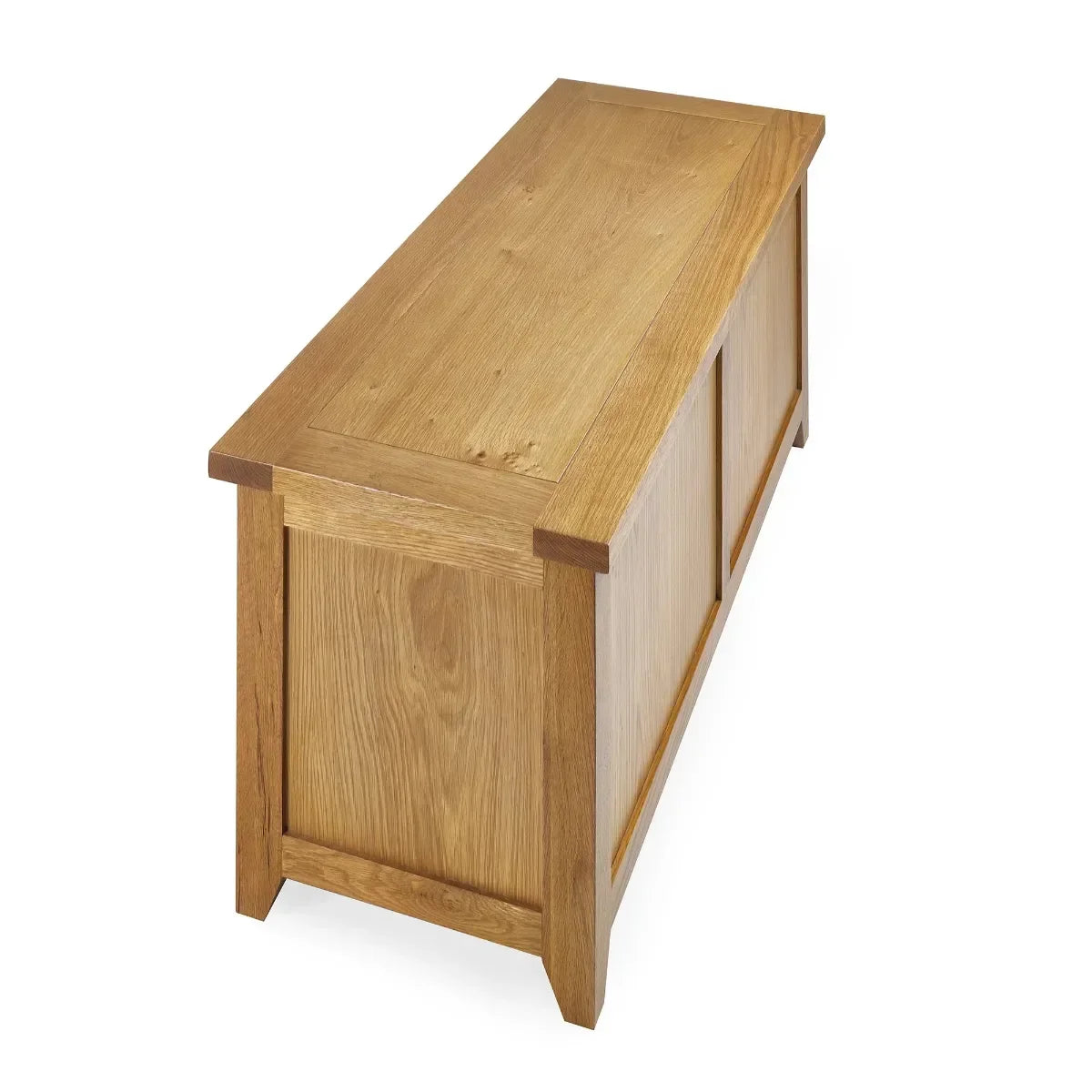 Oak blanket box with panelled sides and lid, angled view on white background