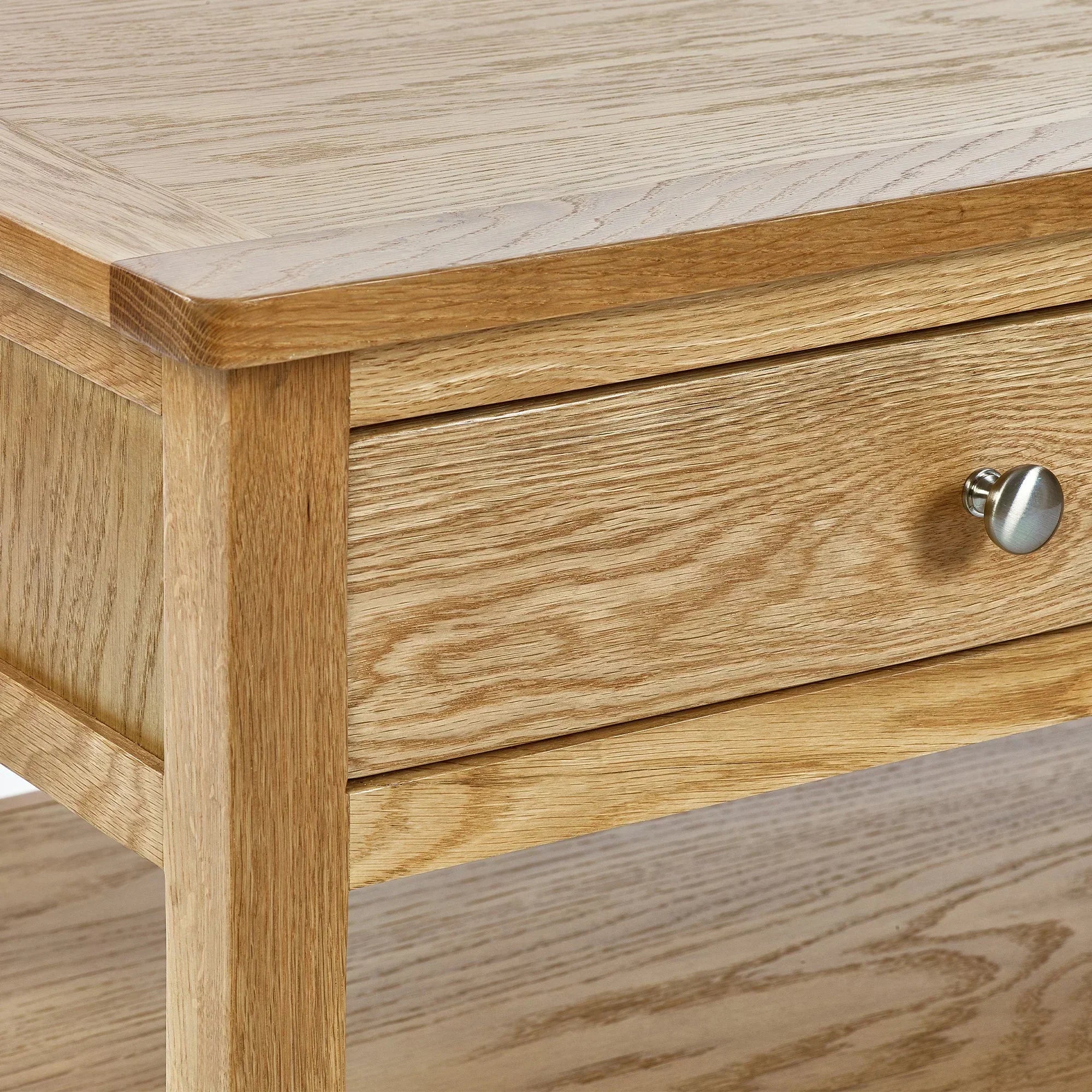 Oak coffee table with drawer and metal knob, showing detailed wood grain finish