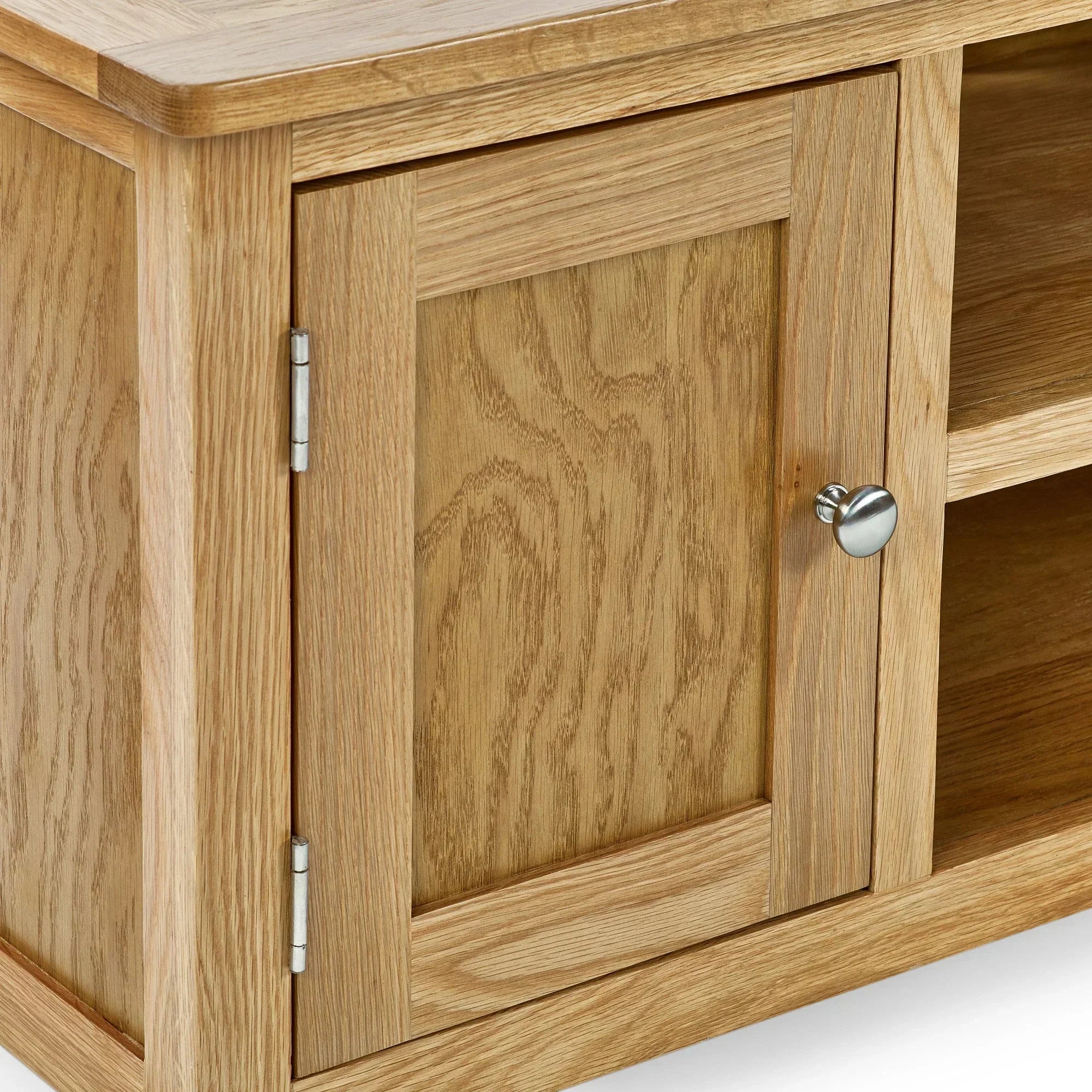 Oak TV unit close up showing door panel, metal handle, and wood grain detail