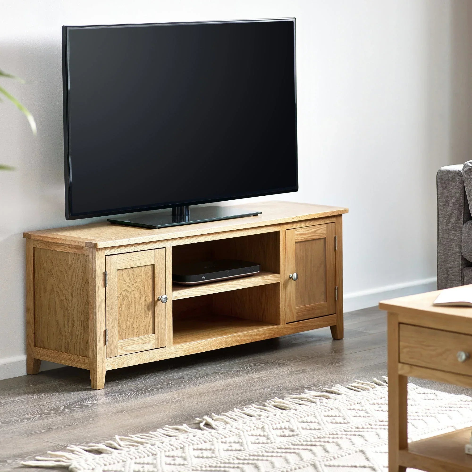 Oak TV unit with storage cabinets and open shelf in modern living room