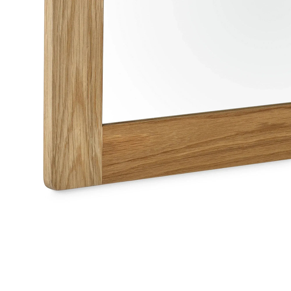 Oak wall mirror with visible wood grain close-up of frame corner