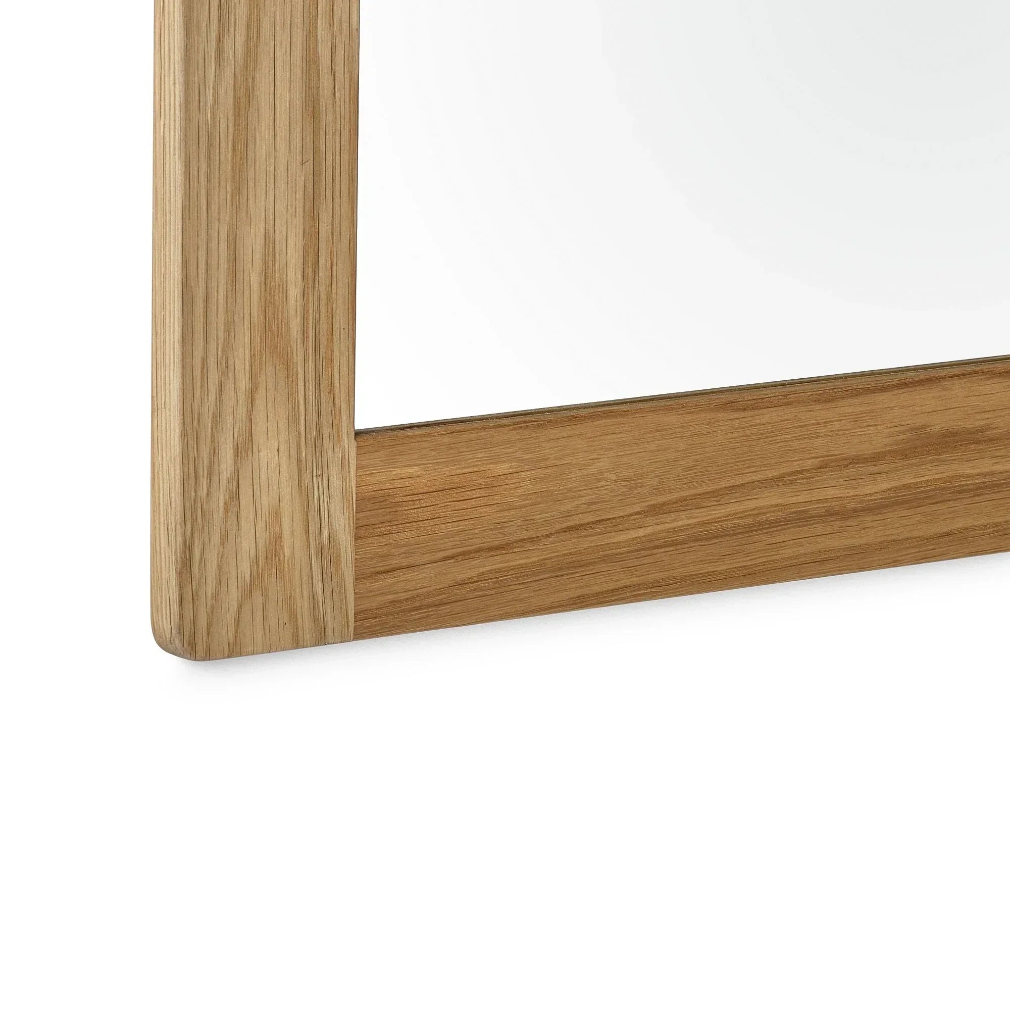 Oak wall mirror with visible wood grain close-up of frame corner