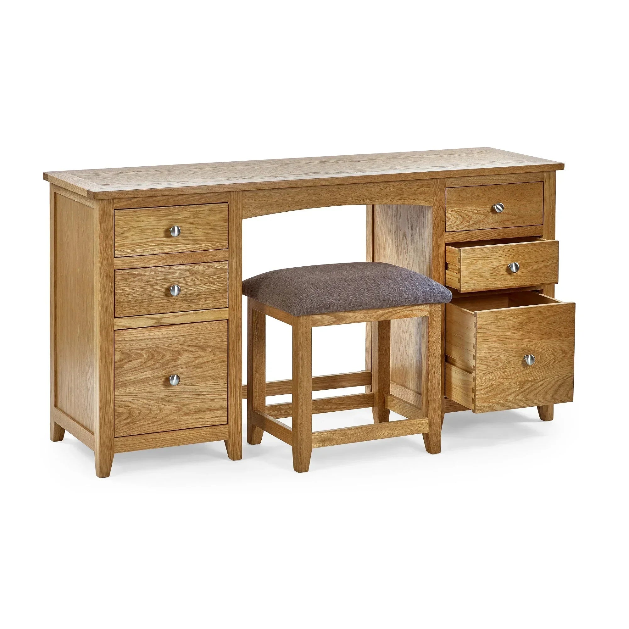 Oak dressing table with six drawers and matching cushioned stool on white background