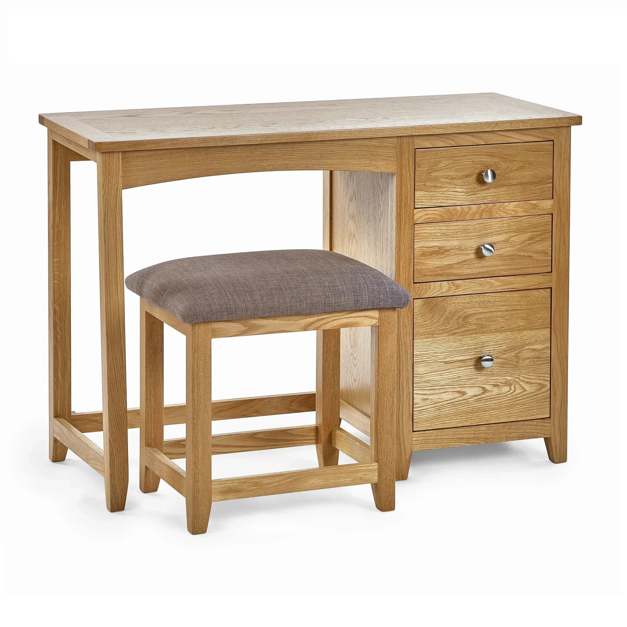 Oak dressing table with three drawers and padded stool on white background