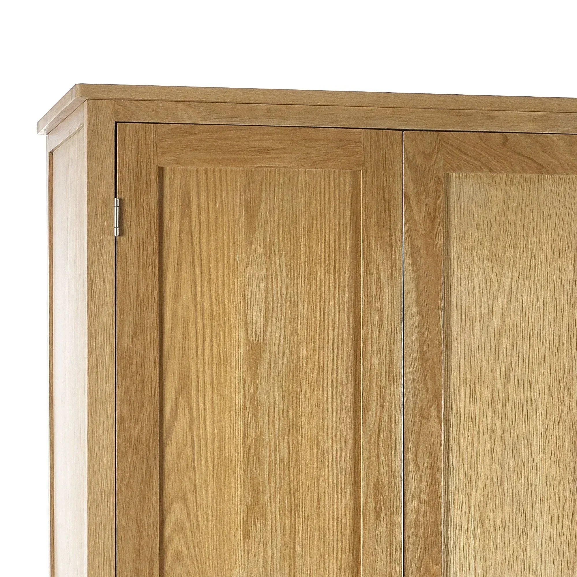Close-up of oak wardrobe top and panelled doors with visible wood grain detail
