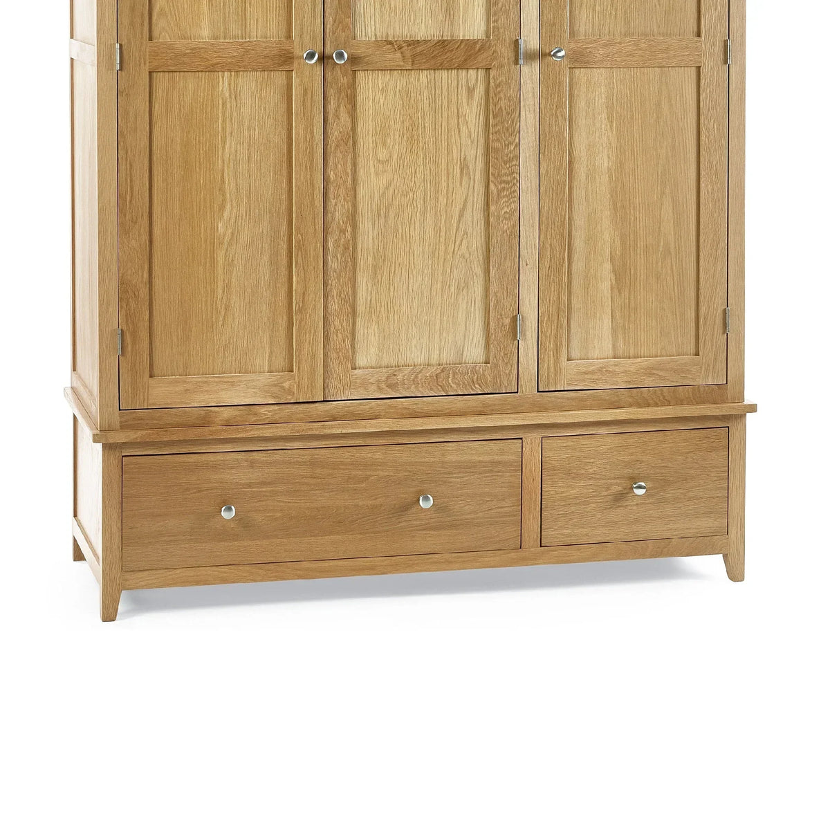 Oak three door wardrobe detail showing wooden panels and two lower drawers with metal knobs