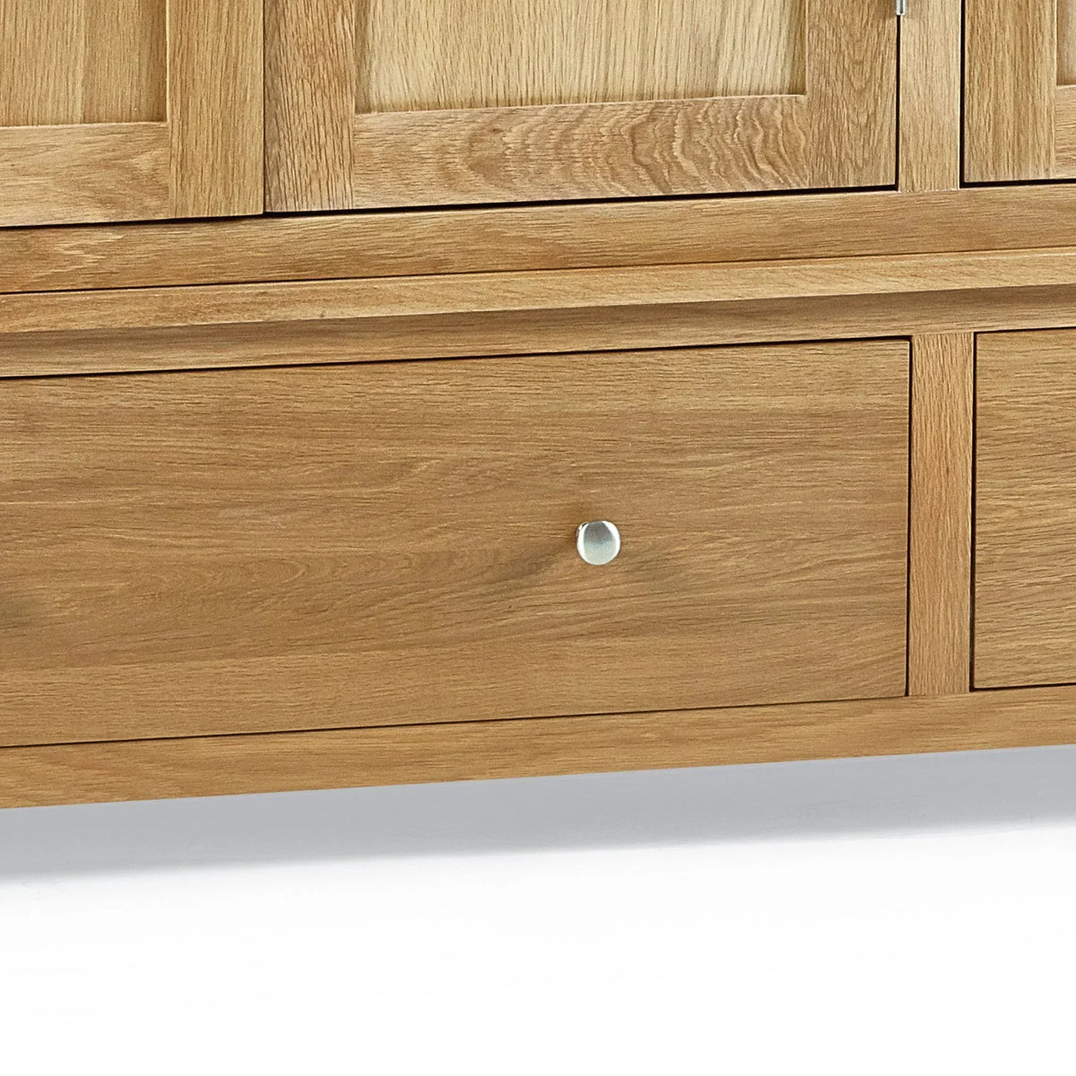 Oak wardrobe lower drawer with silver handle close-up