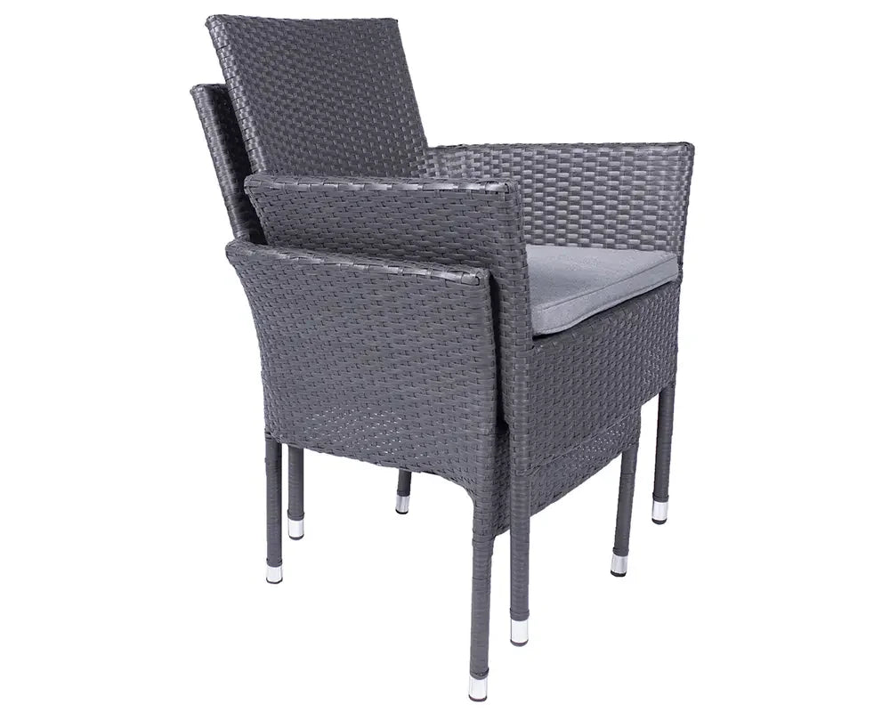 Stacked grey rattan garden chairs with cushions and metal-tipped legs