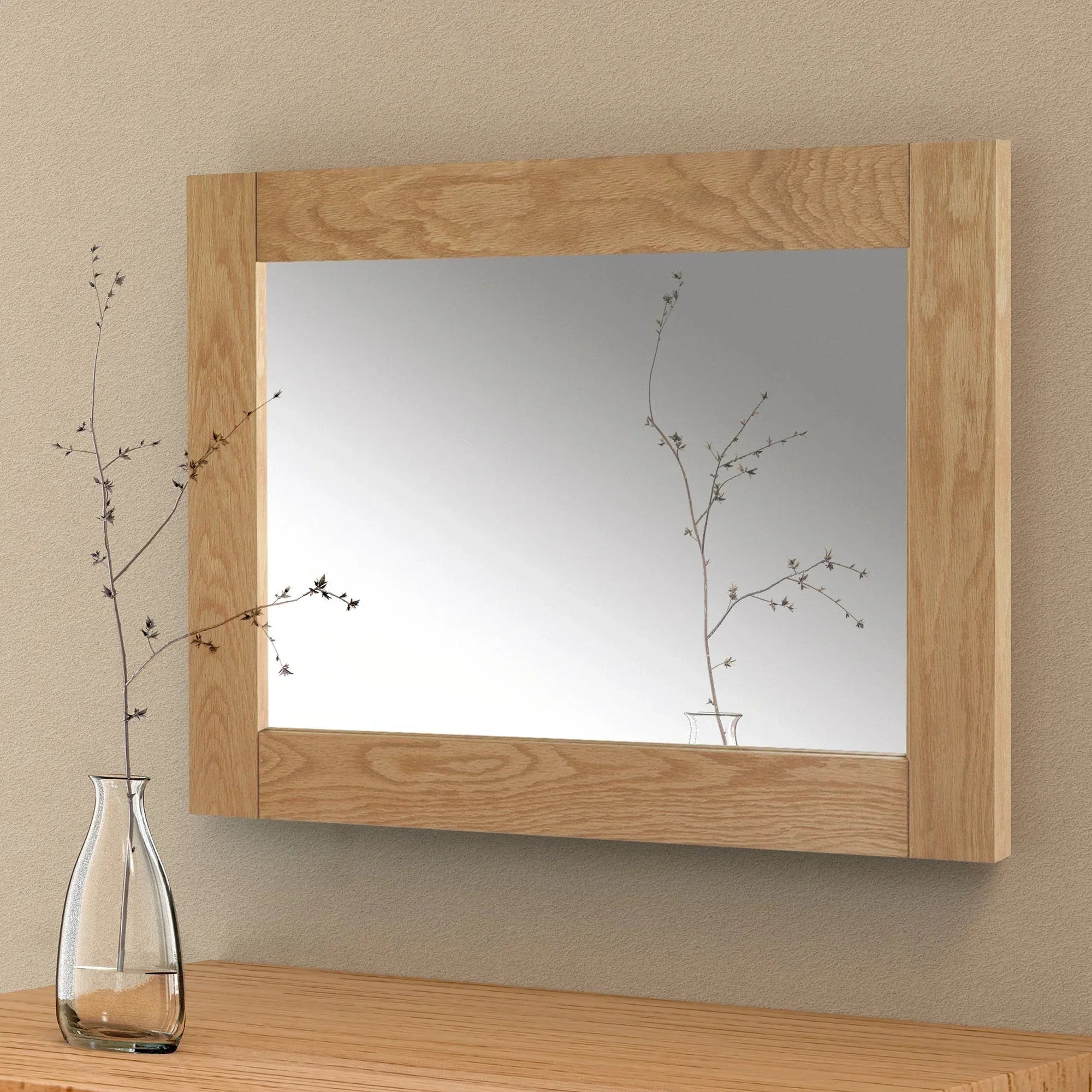 Marlborough wall mirror with oak frame above wooden surface and clear glass vase