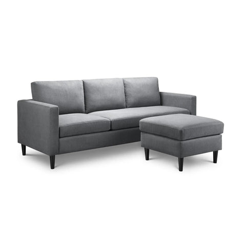 Grey corner sofa with three seat cushions and ottoman on black legs, isolated on white