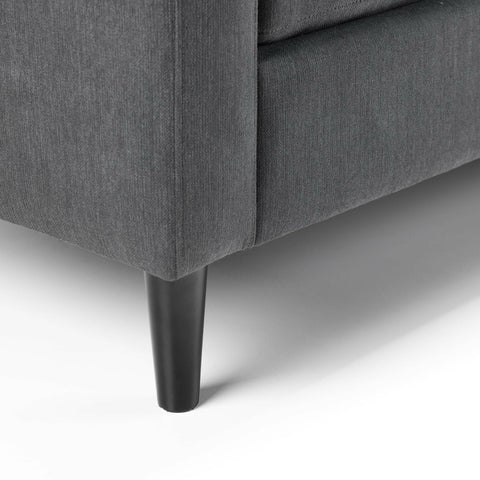 Dark grey corner sofa fabric with black tapered leg, close-up of base detail