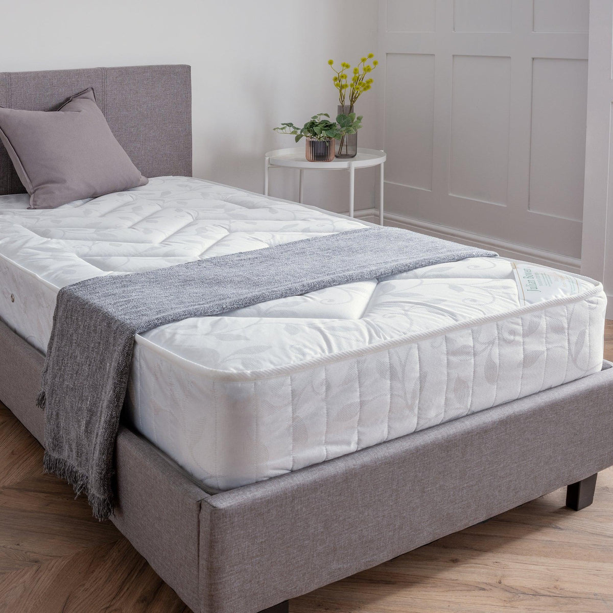 Deluxe semi-orthopaedic 90cm mattress on grey upholstered bed in bright bedroom